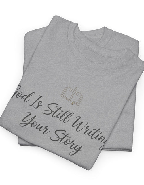 Load image into Gallery viewer, God Is Still Writing Your Story Tee — Inspirational Christian Faith Men's &amp; Women's T-Shirt

