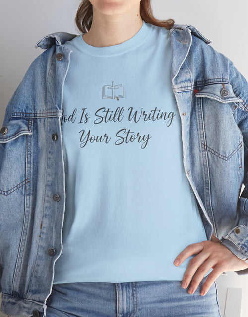 Load image into Gallery viewer, God Is Still Writing Your Story Tee — Inspirational Christian Faith Men's &amp; Women's T-Shirt
