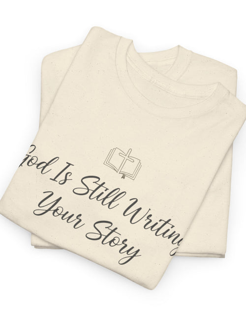 Load image into Gallery viewer, God Is Still Writing Your Story Tee — Inspirational Christian Faith Men's &amp; Women's T-Shirt
