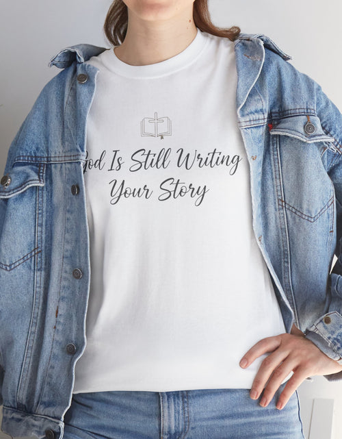 Load image into Gallery viewer, God Is Still Writing Your Story Tee — Inspirational Christian Faith Men's &amp; Women's T-Shirt
