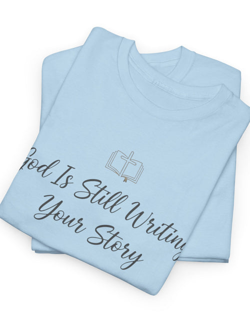 Load image into Gallery viewer, God Is Still Writing Your Story Tee — Inspirational Christian Faith Men's &amp; Women's T-Shirt
