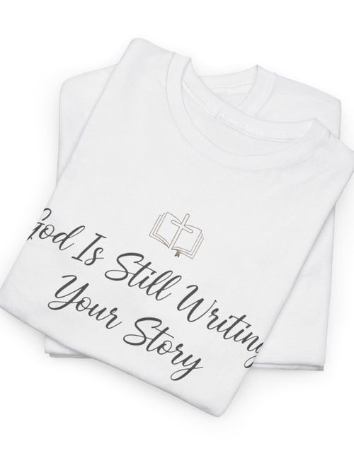Load image into Gallery viewer, God Is Still Writing Your Story Tee — Inspirational Christian Faith Men's &amp; Women's T-Shirt
