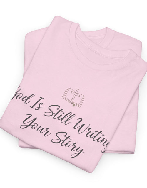 Load image into Gallery viewer, God Is Still Writing Your Story Tee — Inspirational Christian Faith Men's &amp; Women's T-Shirt
